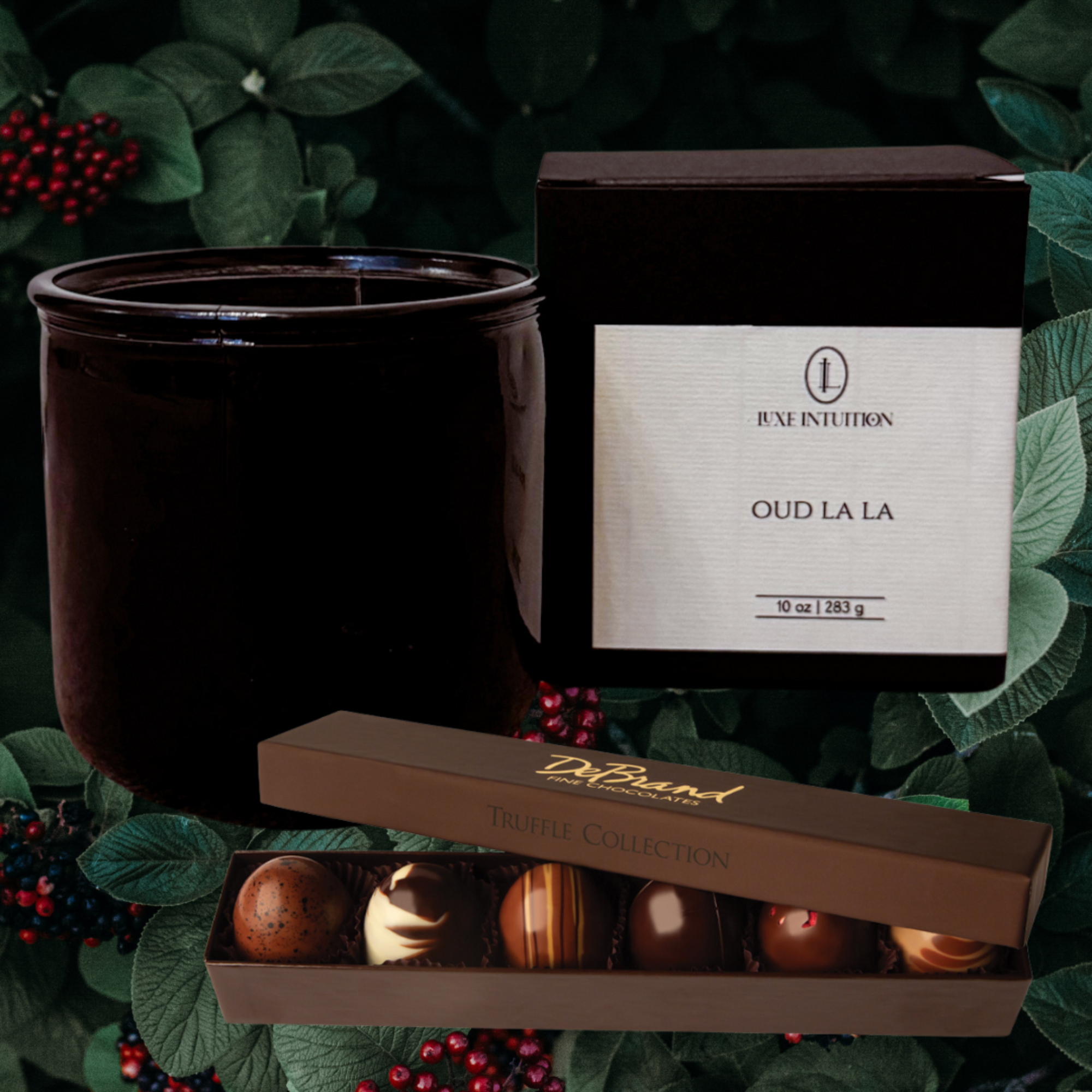 Image of Oud La La wood wick candle and Debrand Fine Chocolates Truffle Assortment on a leaves background